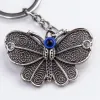 Silver butterfly-shaped keychain with blue evil eye bead decoration, fashionable and personalized pendant gift Application Scenario